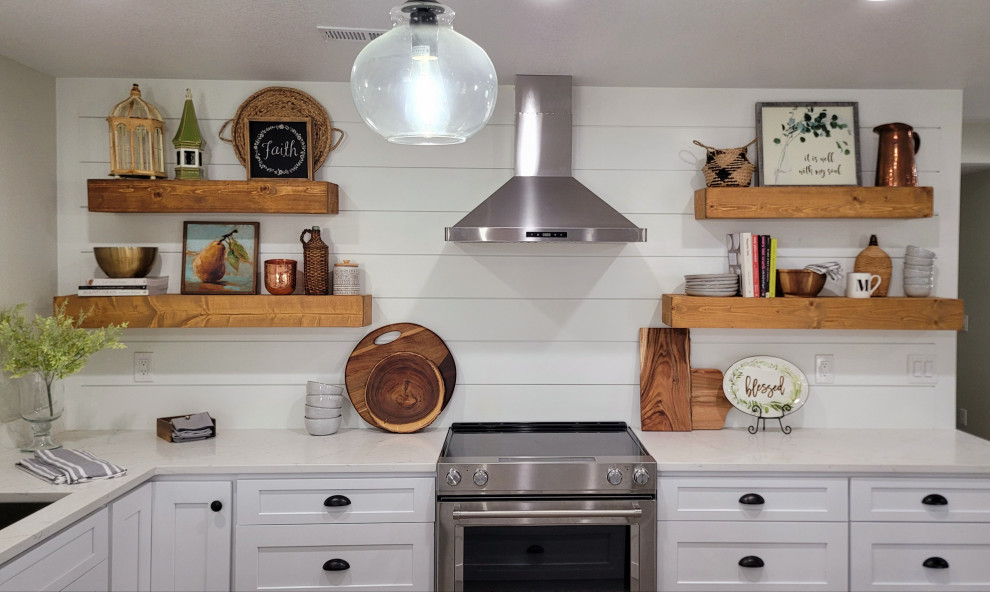 Photo of a country u-shaped kitchen in Denver with shaker cabinets, white cabinets, quartz benchtops, white splashback, shiplap splashback, stainless steel appliances and white benchtop.