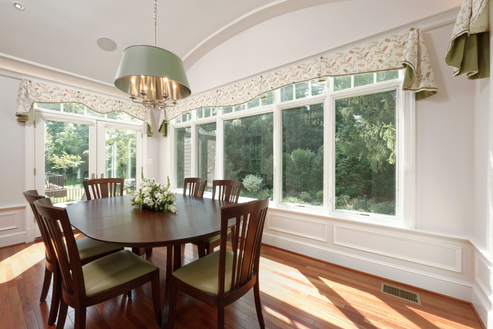 This is an example of a transitional dining room in DC Metro with medium hardwood floors and brown floor.