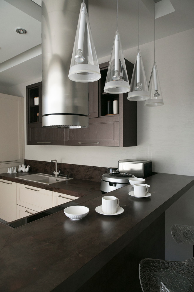Design ideas for a mid-sized contemporary u-shaped separate kitchen in Moscow with recessed-panel cabinets, beige cabinets, solid surface benchtops, porcelain splashback, porcelain floors, a drop-in sink, a peninsula and brown splashback.