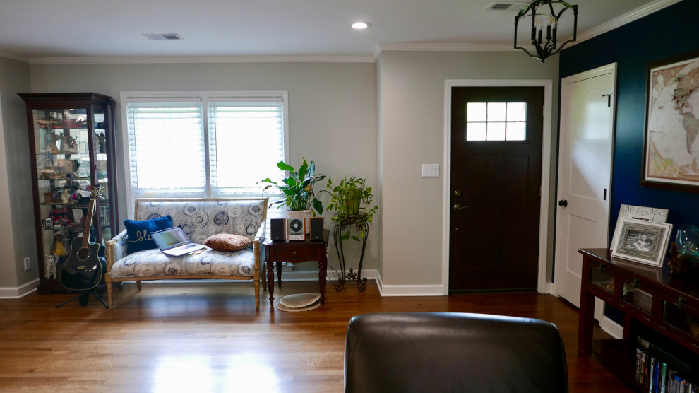 Inspiration for a mid-sized transitional medium tone wood floor and brown floor foyer remodel with gray walls and a dark wood front door