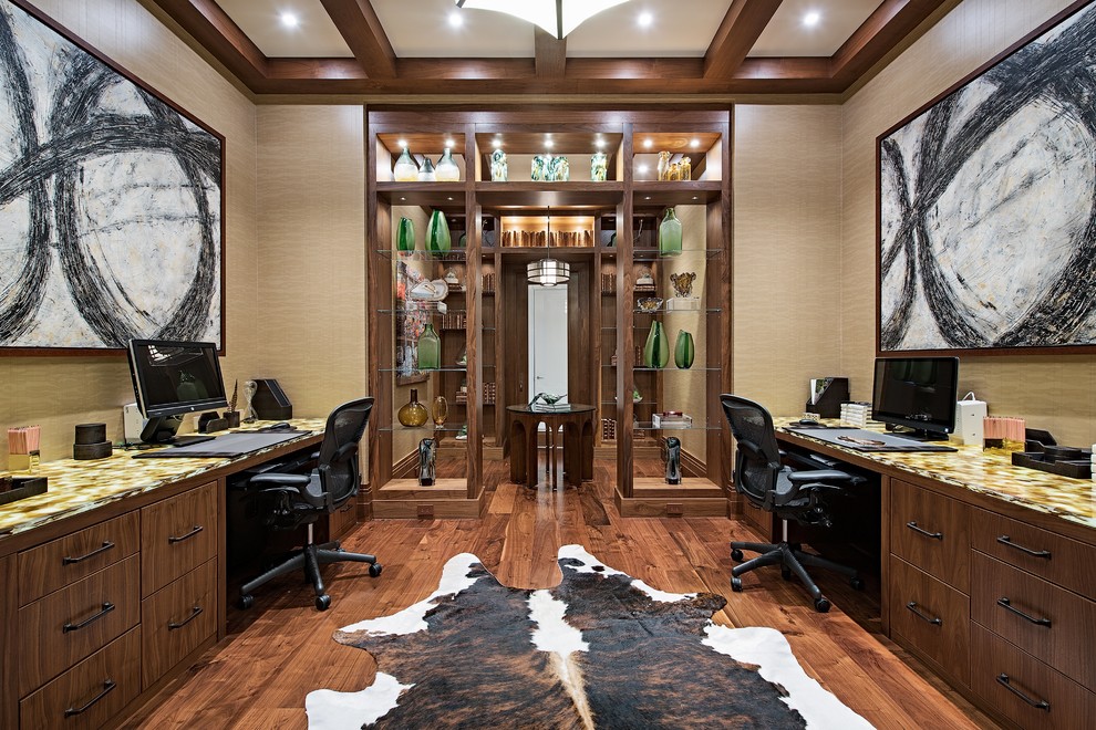 Photo of a transitional study room in Miami with beige walls, dark hardwood floors, a built-in desk and brown floor.
