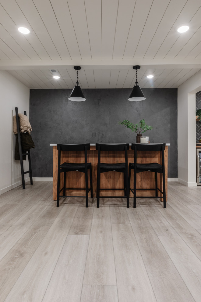 Inspiration for a medium sized modern kitchen/dining room in Cedar Rapids with white walls, vinyl flooring, no fireplace, grey floors and a vaulted ceiling.