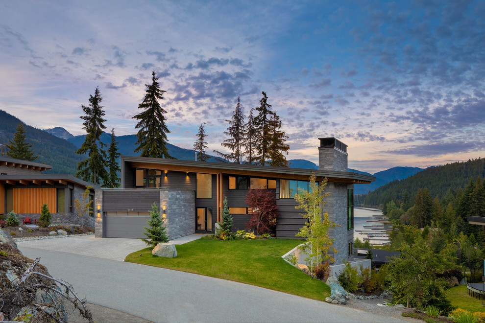Contemporary three-storey grey house exterior in Vancouver with a shed roof.