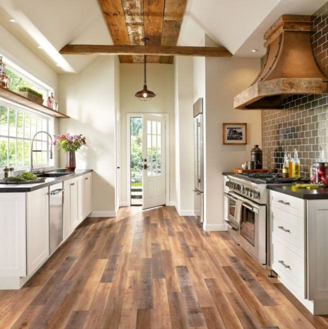 Design ideas for a mid-sized country galley separate kitchen in Atlanta with an undermount sink, shaker cabinets, white cabinets, quartz benchtops, metallic splashback, subway tile splashback, stainless steel appliances, dark hardwood floors, no island, brown floor and grey benchtop.