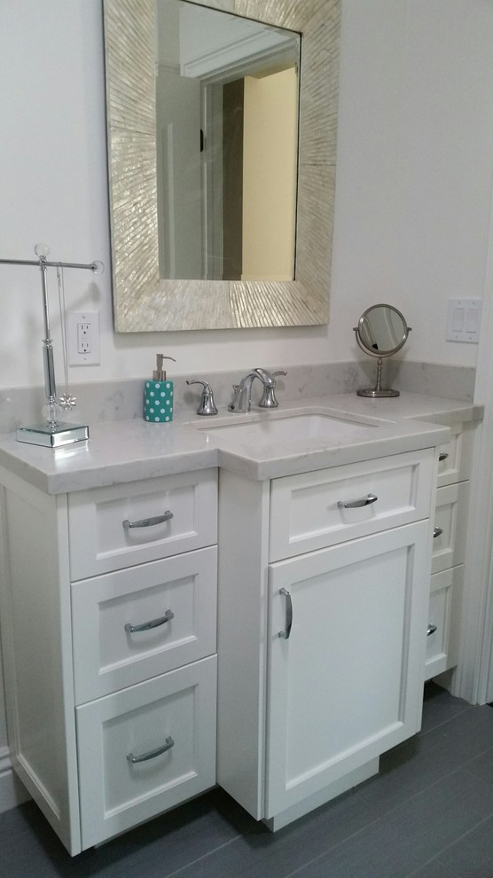 Photo of a small transitional kids bathroom in San Francisco with shaker cabinets, white cabinets, engineered quartz benchtops, grey walls and porcelain floors.