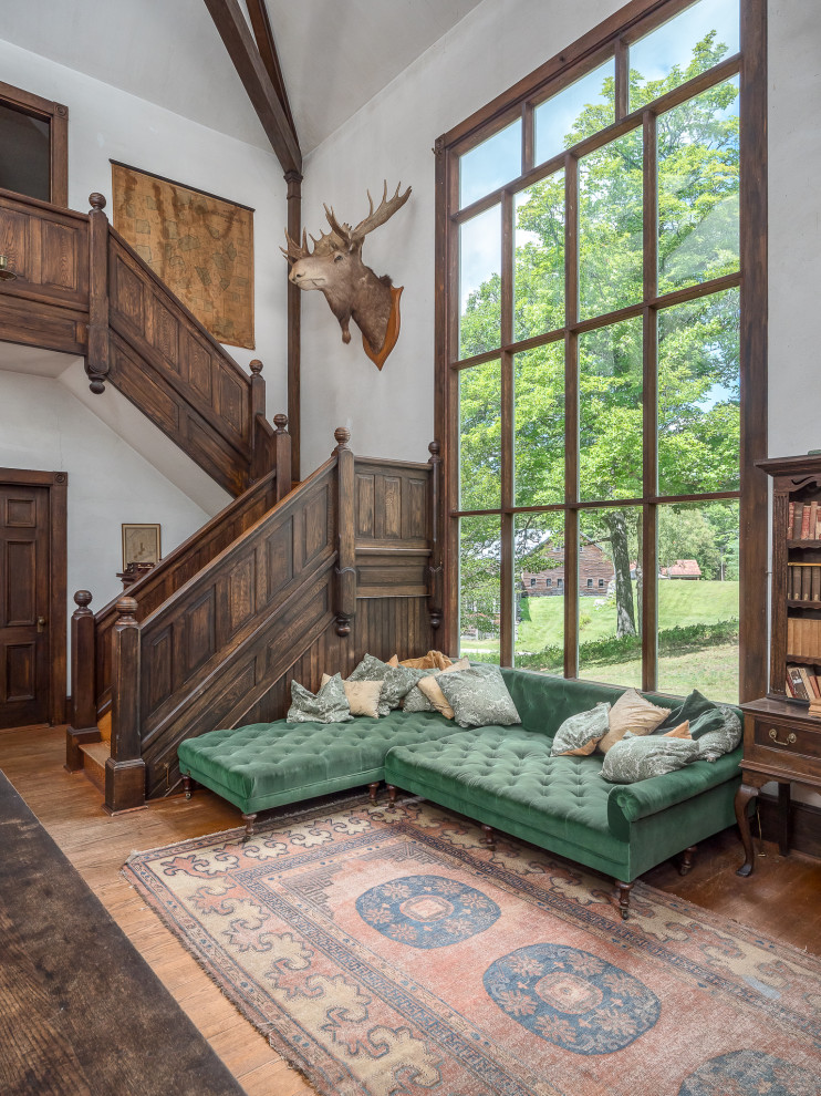 Family room - huge farmhouse open concept medium tone wood floor family room idea in Portland Maine with white walls, a standard fireplace and a brick fireplace