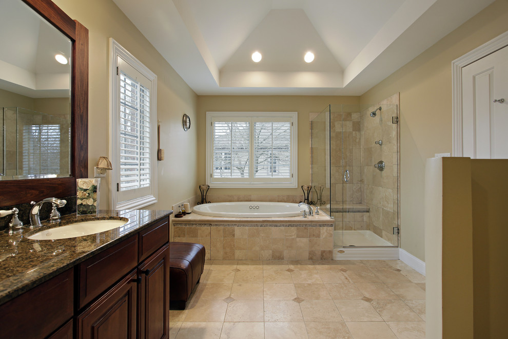 Design ideas for a large traditional master bathroom in San Diego with flat-panel cabinets, brown cabinets, a drop-in tub, an open shower, a two-piece toilet, beige tile, ceramic tile, white walls, ceramic floors, a pedestal sink and marble benchtops.
