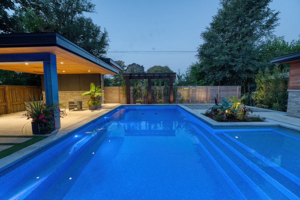 Large modern backyard rectangular pool in Toronto with with a pool.