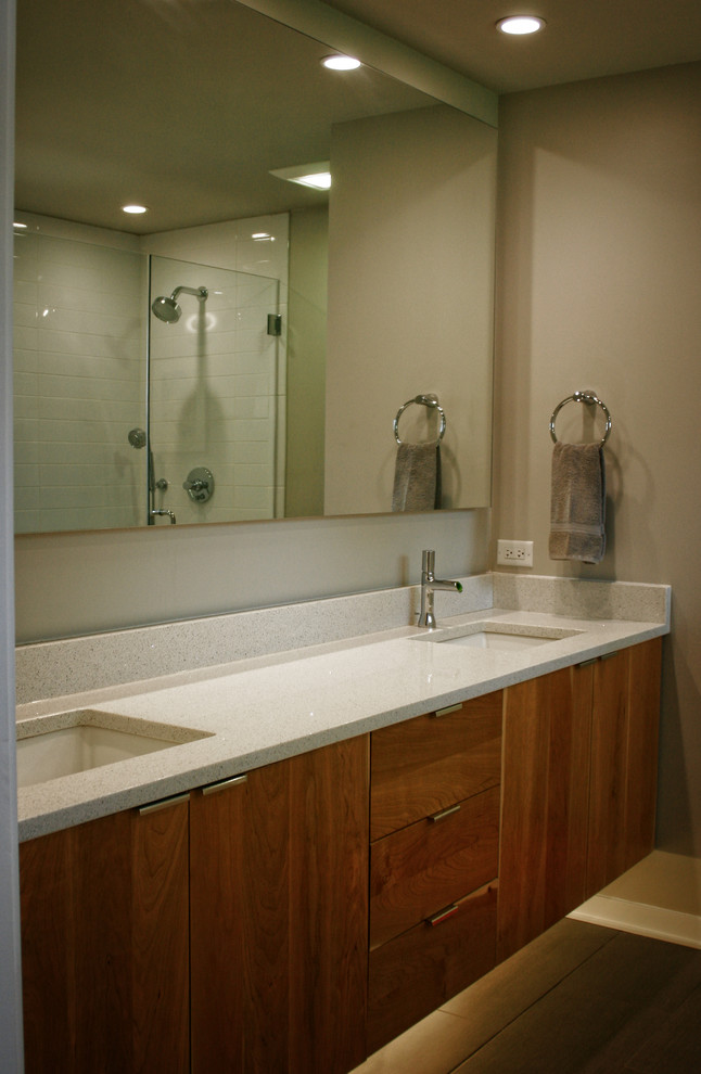 Mid-sized midcentury master bathroom in Chicago with terrazzo benchtops, furniture-like cabinets, light wood cabinets, an undermount tub, a corner shower, white tile, subway tile, brown walls, porcelain floors and an undermount sink.