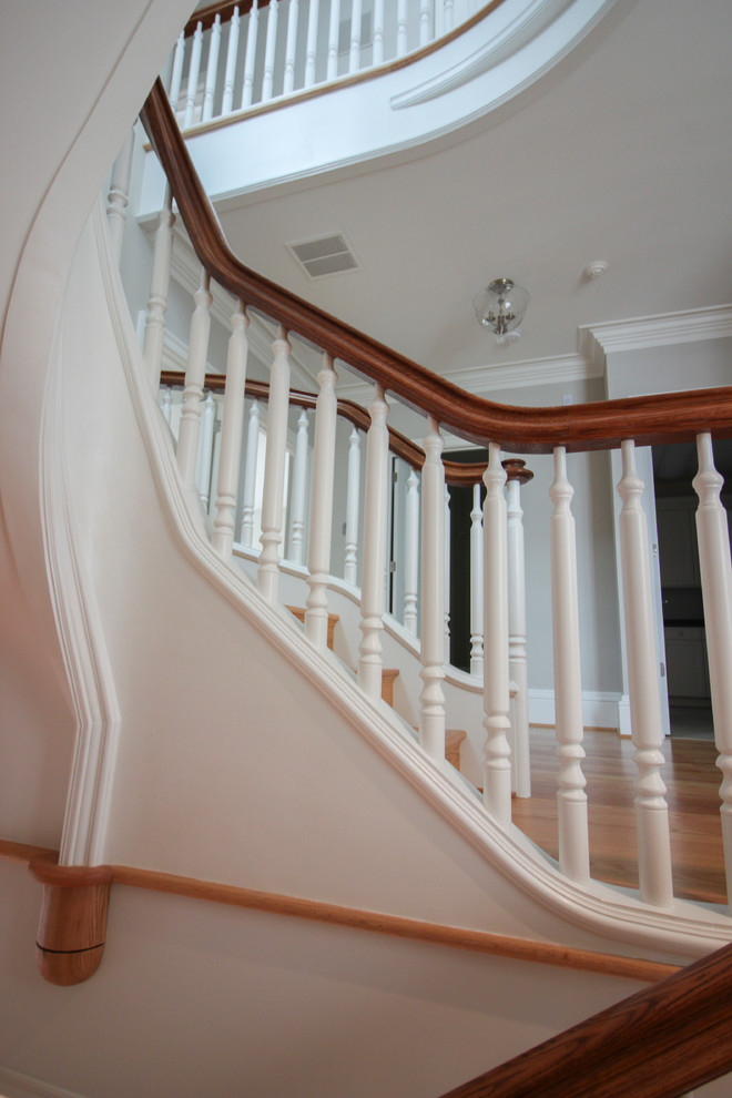 Design ideas for an expansive traditional wood u-shaped staircase in DC Metro with wood risers and wood railing.