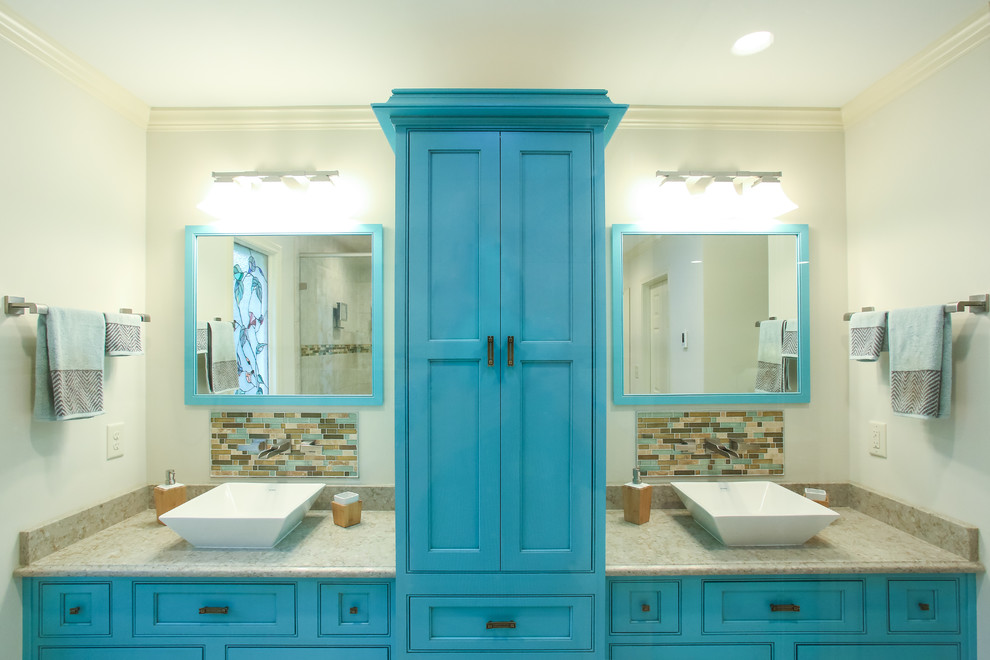 Photo of a mid-sized beach style bathroom in Atlanta with beaded inset cabinets, blue cabinets, mirror tile, a vessel sink and soapstone benchtops.