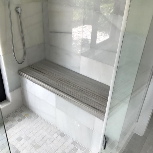 Inspiration for a large contemporary master bathroom in Miami with flat-panel cabinets, white cabinets, an alcove shower, white walls, porcelain floors, an undermount sink, solid surface benchtops, grey floor and a hinged shower door.
