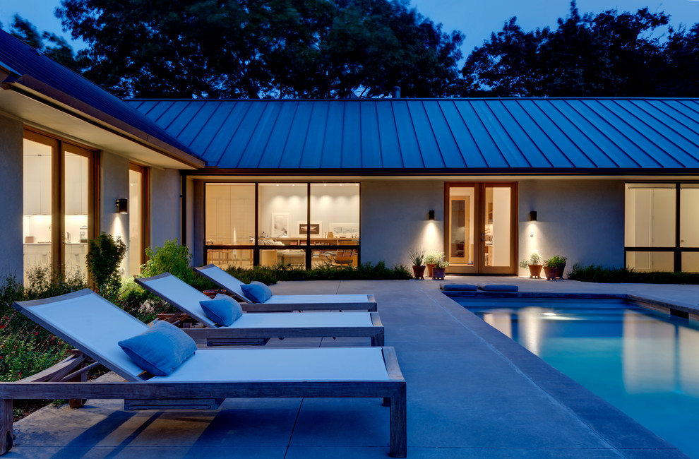 Inspiration for a contemporary courtyard rectangular lap pool in Dallas with concrete slab.