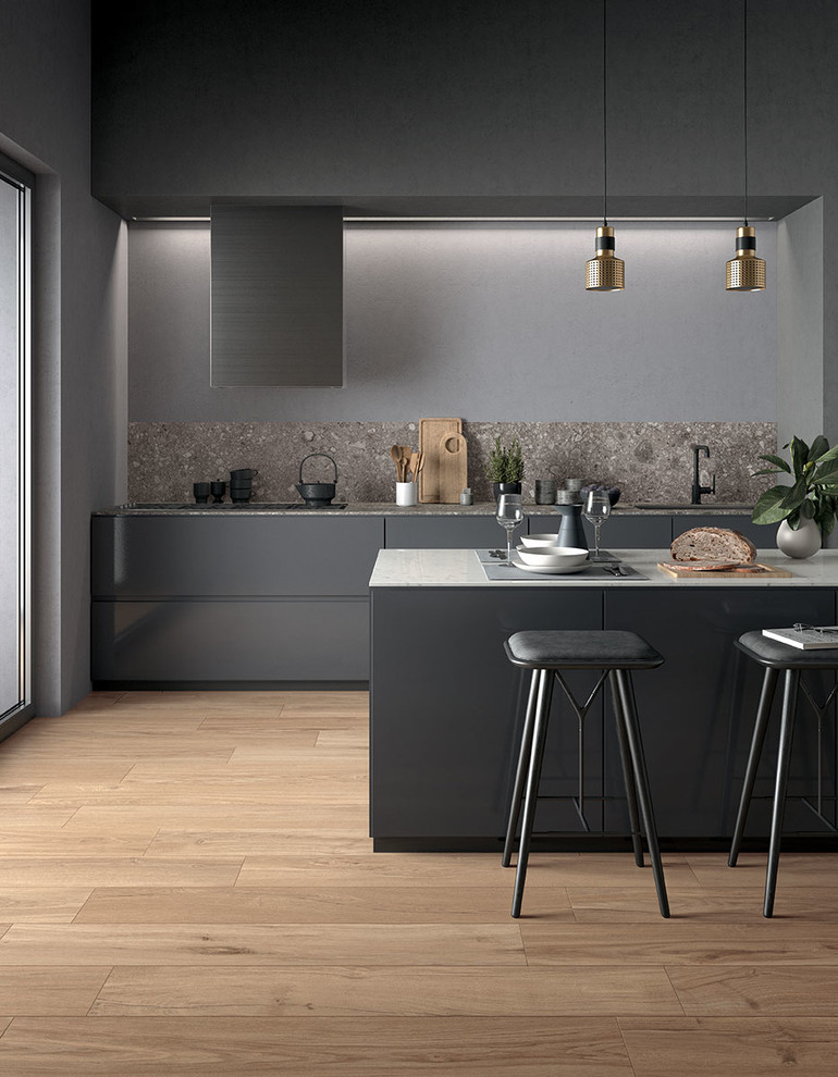 Inspiration for a contemporary galley kitchen in Perth with an undermount sink, flat-panel cabinets, grey cabinets, tile benchtops, grey splashback, porcelain splashback, black appliances, porcelain floors and with island.