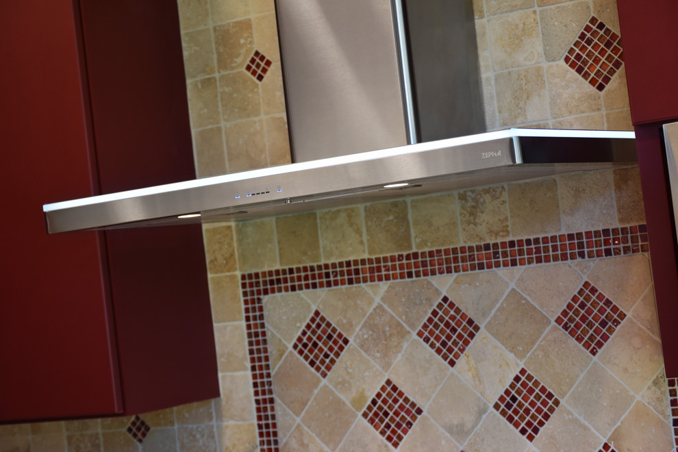 Enclosed kitchen - large transitional porcelain tile and beige floor enclosed kitchen idea with an undermount sink, flat-panel cabinets, red cabinets, granite countertops, beige backsplash, travertine backsplash, stainless steel appliances and an island