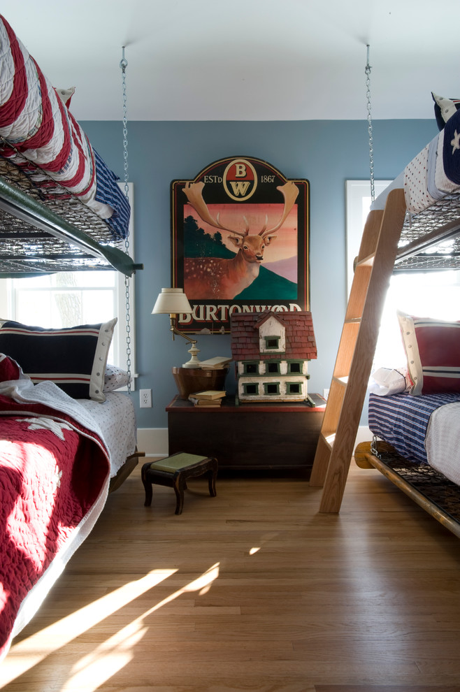 Country bedroom in Minneapolis with grey walls and medium hardwood floors.