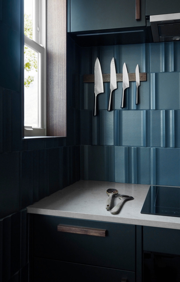 Design ideas for a small modern kitchen in San Francisco with blue cabinets, concrete worktops, blue splashback, ceramic splashback, black appliances, a breakfast bar and grey worktops.
