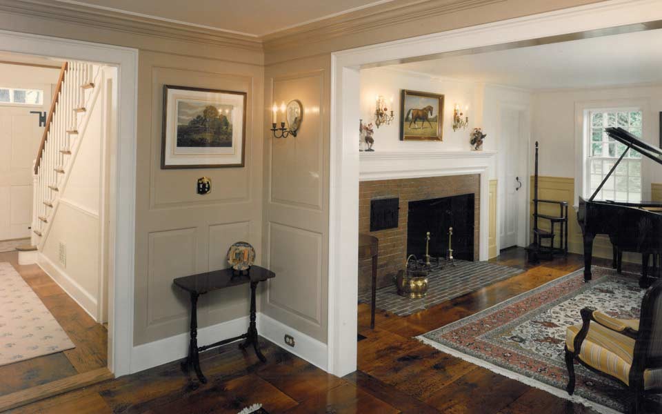Inspiration for a large country formal living room in Boston with beige walls, dark hardwood floors, a standard fireplace and a wood fireplace surround.