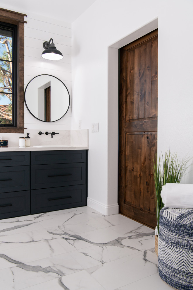 Inspiration for a mediterranean bathroom in Orange County with blue cabinets, an alcove shower, white walls, porcelain floors, a drop-in sink, quartzite benchtops, an open shower, white benchtops, a double vanity, a built-in vanity and planked wall panelling.