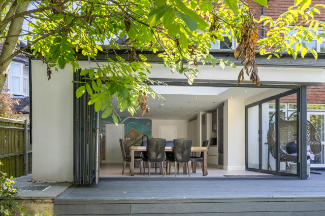 Raised Garden Decking and Rear Extension with Corner Bifolds Open, Epsom, Surrey contemporary-terrace
