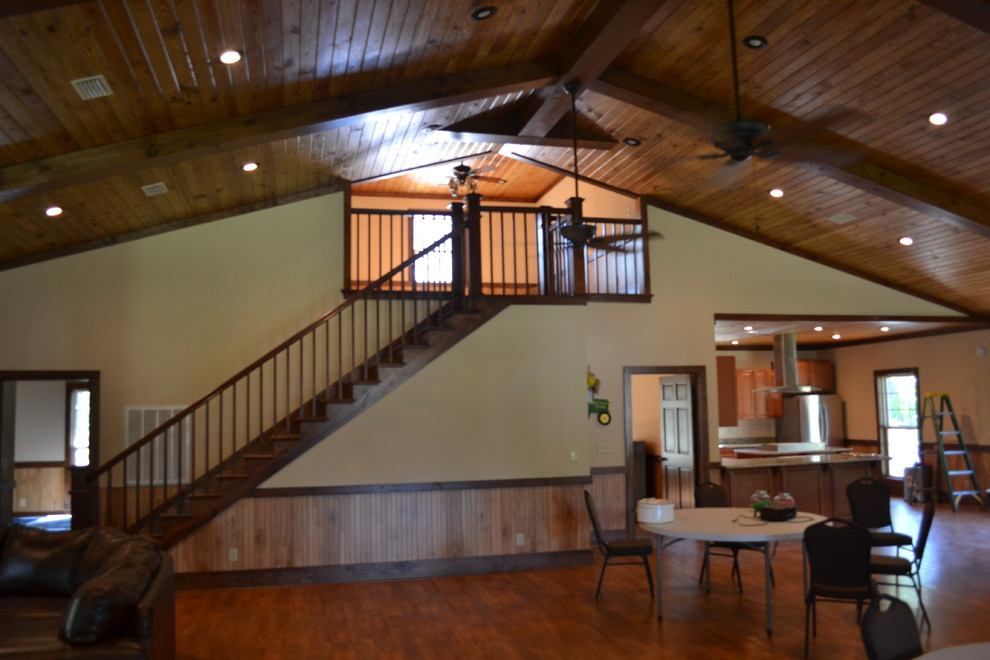 Mid-sized mountain style u-shaped medium tone wood floor kitchen photo in Atlanta with raised-panel cabinets, brown cabinets, granite countertops, stainless steel appliances and an island