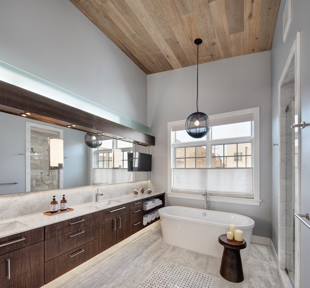 Inspiration for a large transitional master wet room bathroom in Chicago with flat-panel cabinets, dark wood cabinets, a freestanding tub, gray tile, grey walls, an undermount sink, stone slab, marble floors and marble benchtops.