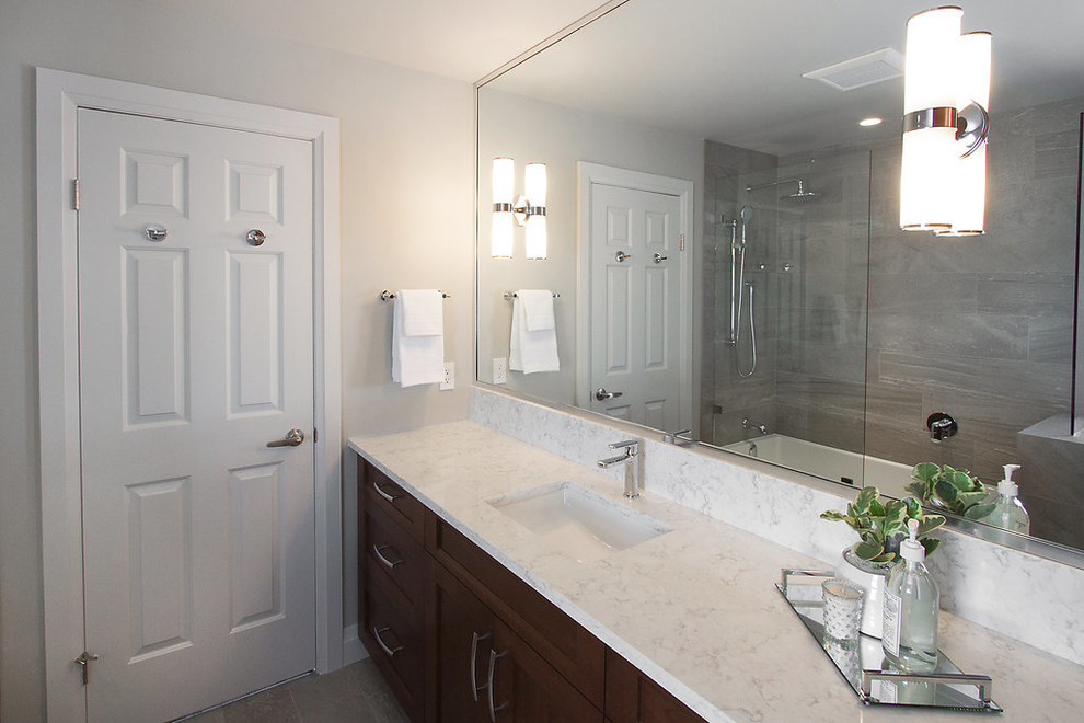 Alcove bathtub - mid-sized modern master gray tile and porcelain tile porcelain tile alcove bathtub idea in Vancouver with an undermount sink, shaker cabinets, medium tone wood cabinets, quartz countertops, a two-piece toilet and gray walls