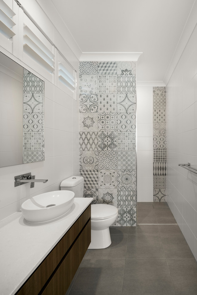 Inspiration for a contemporary 3/4 bathroom in Brisbane with flat-panel cabinets, dark wood cabinets, an alcove shower, a one-piece toilet, gray tile, white tile, white walls, a vessel sink, grey floor, an open shower and white benchtops.