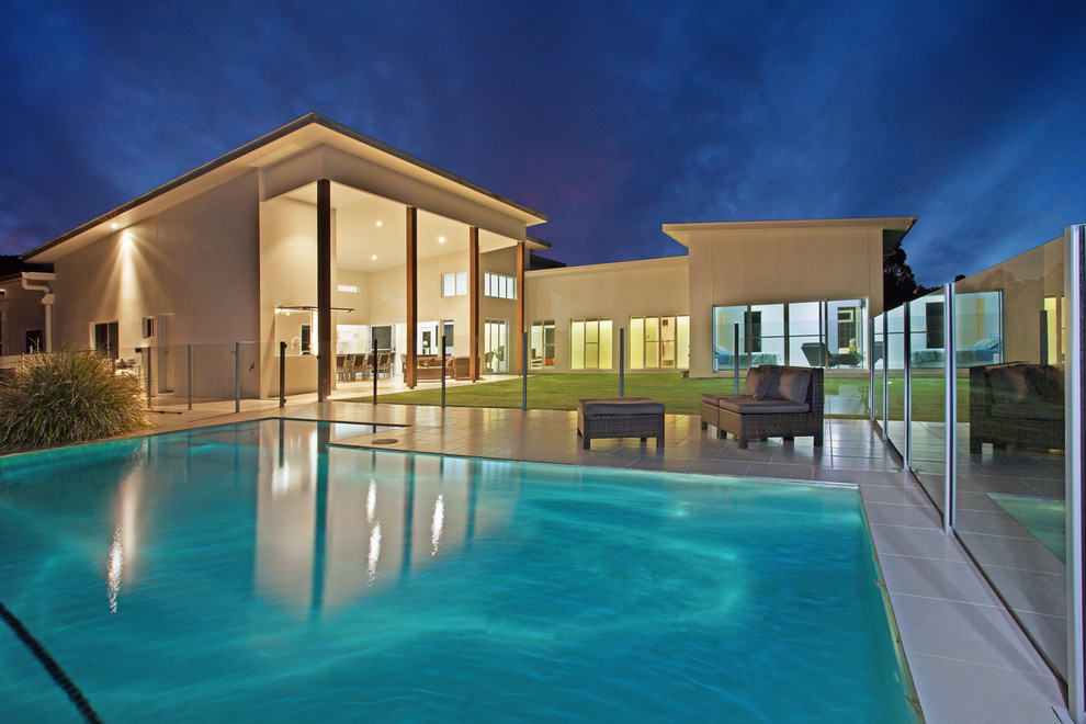 This is an example of a mid-sized contemporary pool in Sunshine Coast with tile.