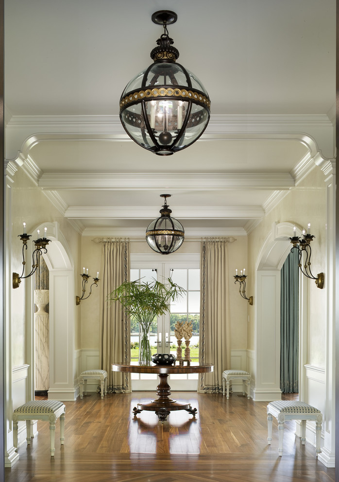 Large traditional foyer in New York with beige walls.