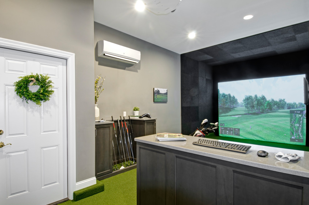 Inspiration for a mid-sized enclosed home theatre in Columbus with grey walls, a projector screen and green floor.