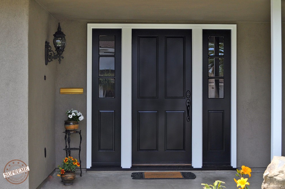 This is an example of a mid-sized traditional front door in Los Angeles with grey walls, concrete floors, a single front door and a blue front door.
