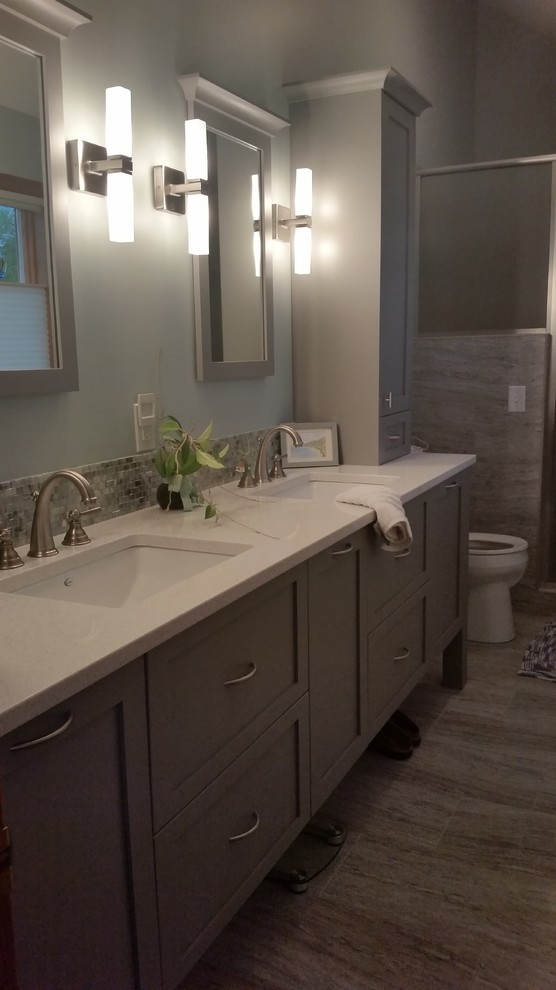 Large transitional master multicolored tile and porcelain tile porcelain tile bathroom photo with flat-panel cabinets, gray cabinets, blue walls, an undermount sink and quartz countertops