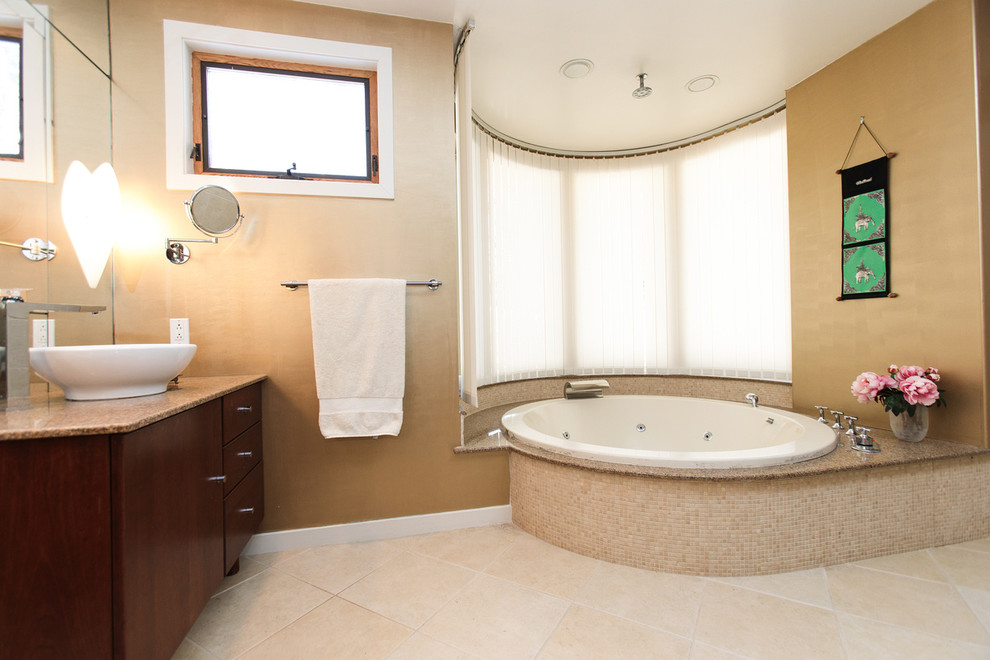 Design ideas for a large modern master bathroom in Boston with flat-panel cabinets, brown cabinets, an alcove tub, an open shower, a one-piece toilet, beige tile, ceramic tile, beige walls, ceramic floors, a vessel sink and solid surface benchtops.