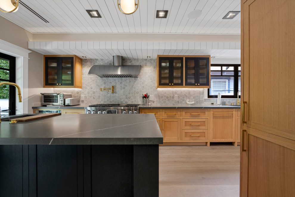 Inspiration for an expansive scandinavian eat-in kitchen in Los Angeles with an undermount sink, shaker cabinets, light wood cabinets, quartzite benchtops, grey splashback, ceramic splashback, stainless steel appliances, light hardwood floors, with island and grey benchtop.