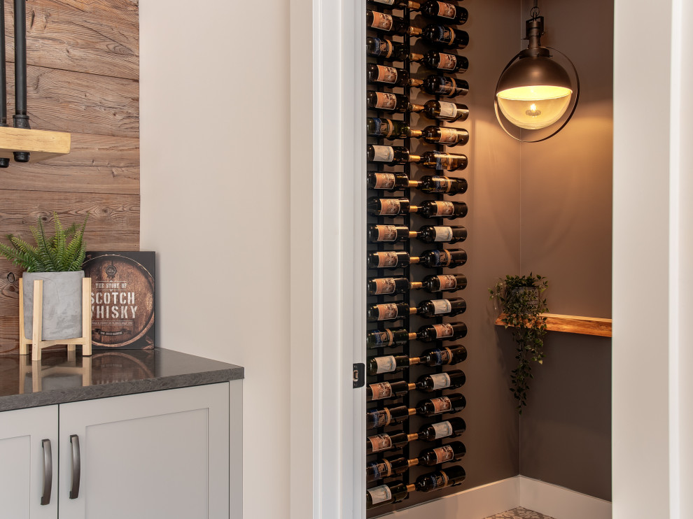 Inspiration for a small transitional wine cellar in Other with porcelain floors, storage racks and multi-coloured floor.