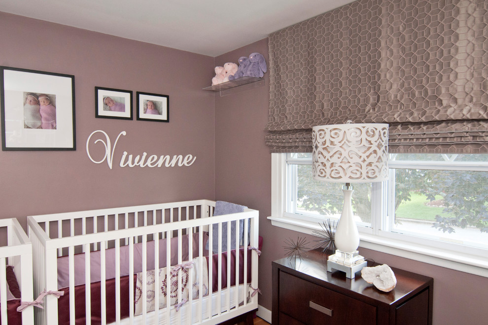 Mid-sized modern nursery in Other with purple walls and light hardwood floors for girls.