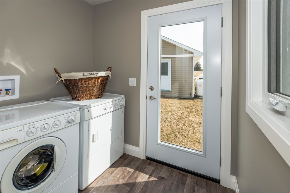 Inspiration for a mid-sized transitional single-wall medium tone wood floor and brown floor dedicated laundry room remodel with gray walls and a side-by-side washer/dryer