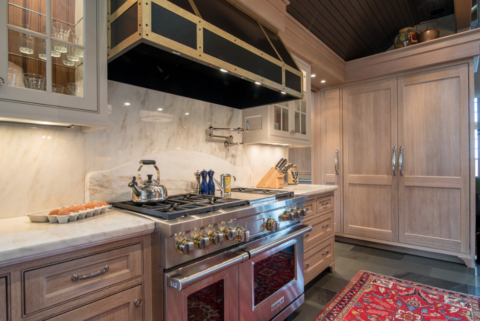 Large transitional u-shaped slate floor and gray floor eat-in kitchen photo in Boston with an undermount sink, shaker cabinets, light wood cabinets, quartz countertops, white backsplash, stone slab backsplash, paneled appliances and an island