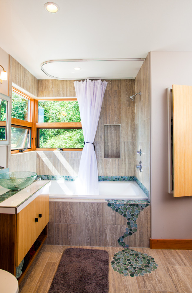 This is an example of a contemporary bathroom in Seattle with a vessel sink, flat-panel cabinets, medium wood cabinets, an alcove tub, a shower/bathtub combo and brown tile.