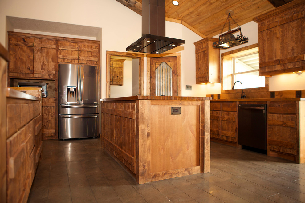 This is an example of a large country l-shaped kitchen in Houston with a drop-in sink, flat-panel cabinets, medium wood cabinets, wood benchtops, stainless steel appliances, dark hardwood floors, multiple islands, brown floor and brown benchtop.