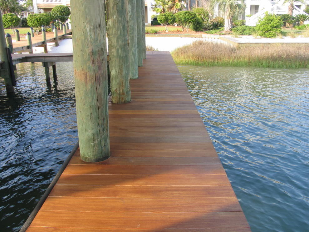 Inspiration for a mid-sized traditional backyard deck in Miami with with dock and a pergola.