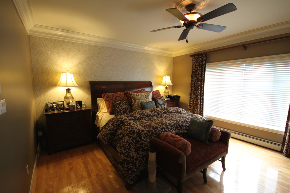 Photo of a mid-sized eclectic master bedroom in Other with beige walls and light hardwood floors.