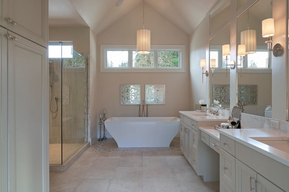 Example of a mid-sized transitional master travertine tile and beige tile travertine floor and beige floor freestanding bathtub design in Phoenix with beaded inset cabinets, beige cabinets, beige walls, an undermount sink, marble countertops and a hinged shower door