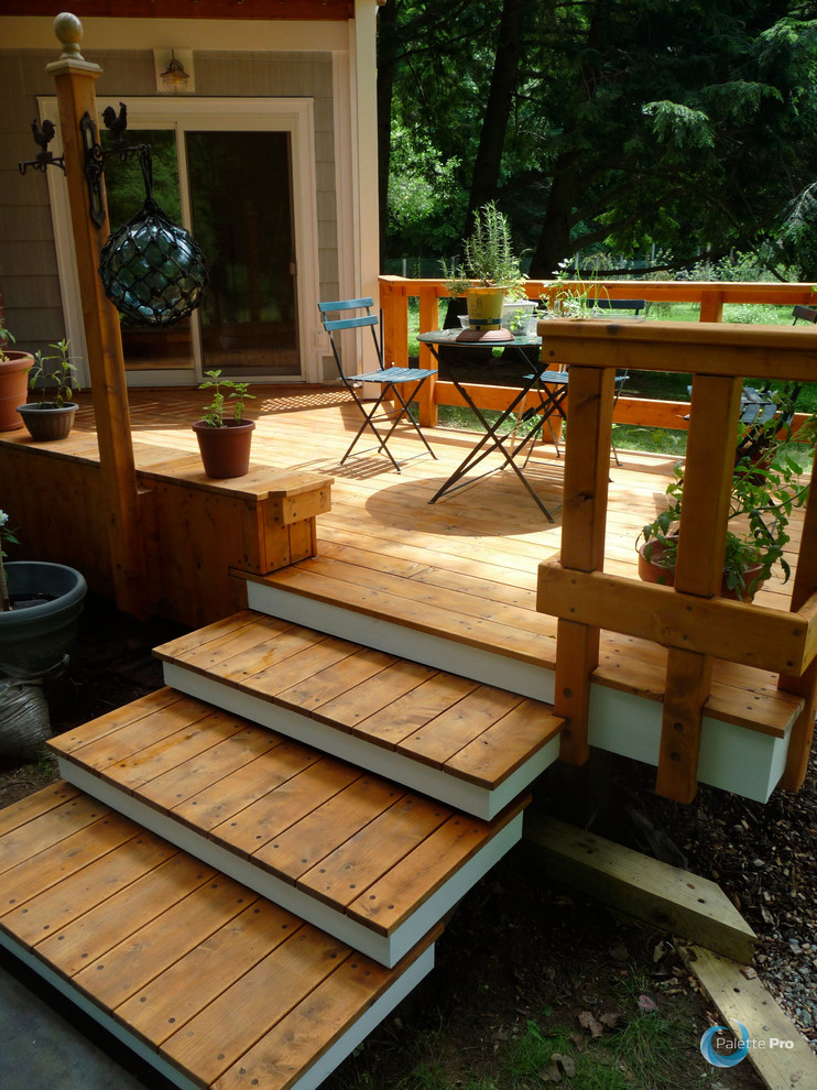 Photo of a large backyard deck in New York with no cover.