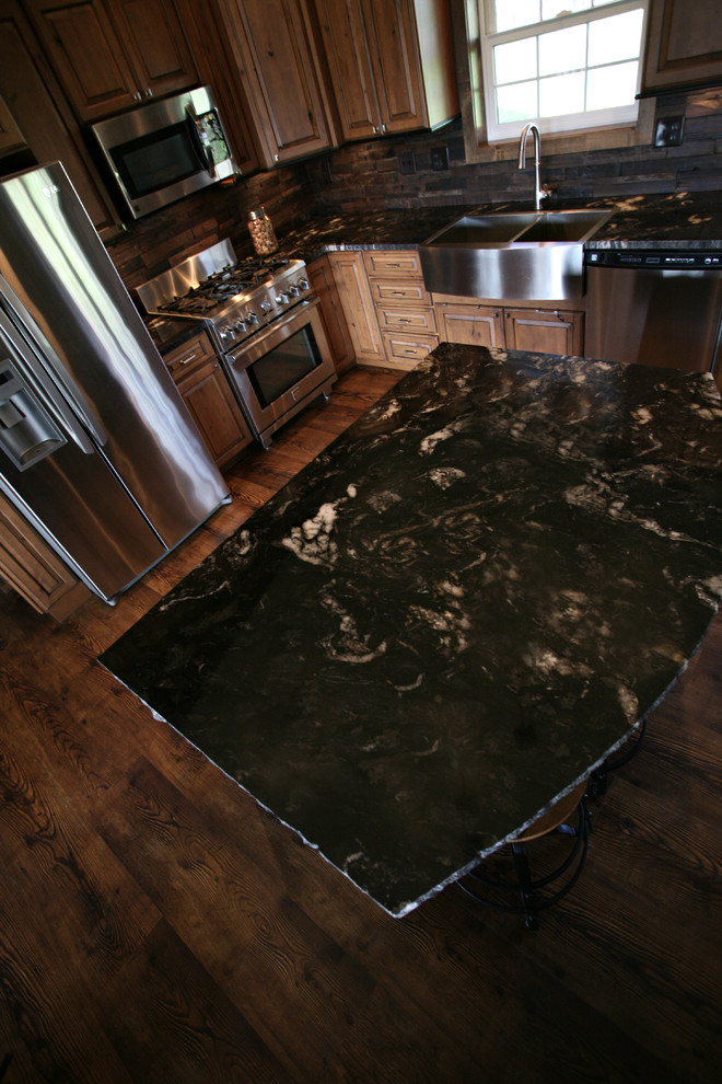 Mid-sized mountain style l-shaped dark wood floor and brown floor open concept kitchen photo in Minneapolis with a farmhouse sink, raised-panel cabinets, medium tone wood cabinets, granite countertops, brown backsplash, wood backsplash, stainless steel appliances and an island