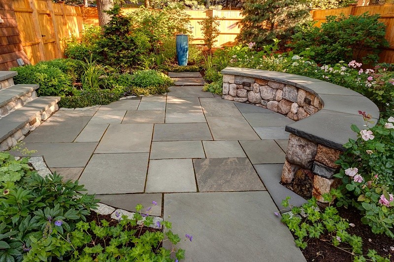 This is an example of a mid-sized contemporary backyard partial sun formal garden for spring in Boston with a garden path and natural stone pavers.