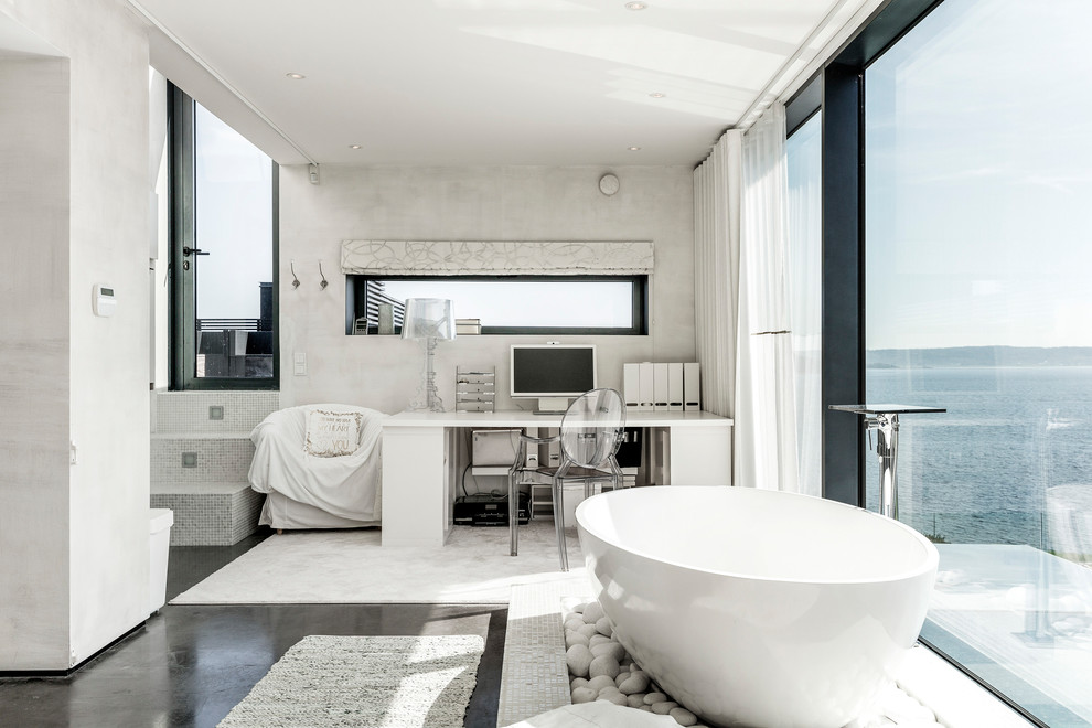 Photo of a large contemporary master bathroom in Gothenburg with a freestanding tub, grey walls, black floor and grey benchtops.