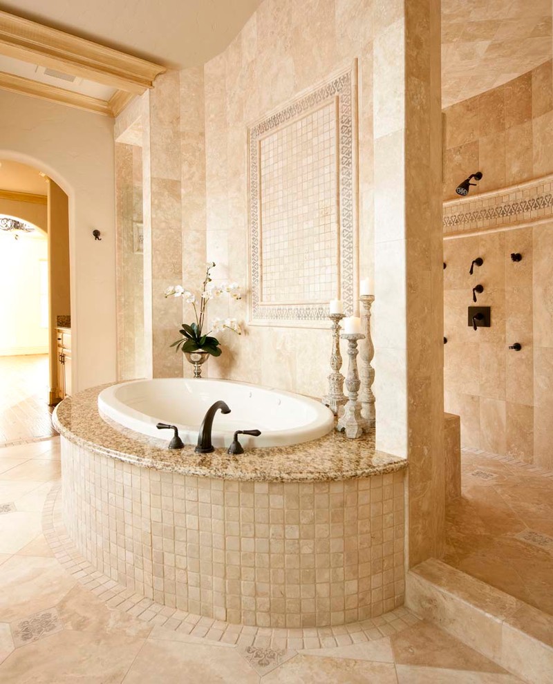Photo of a large mediterranean master bathroom in Dallas with granite benchtops, a drop-in tub, an open shower, beige tile, stone tile, beige walls and travertine floors.