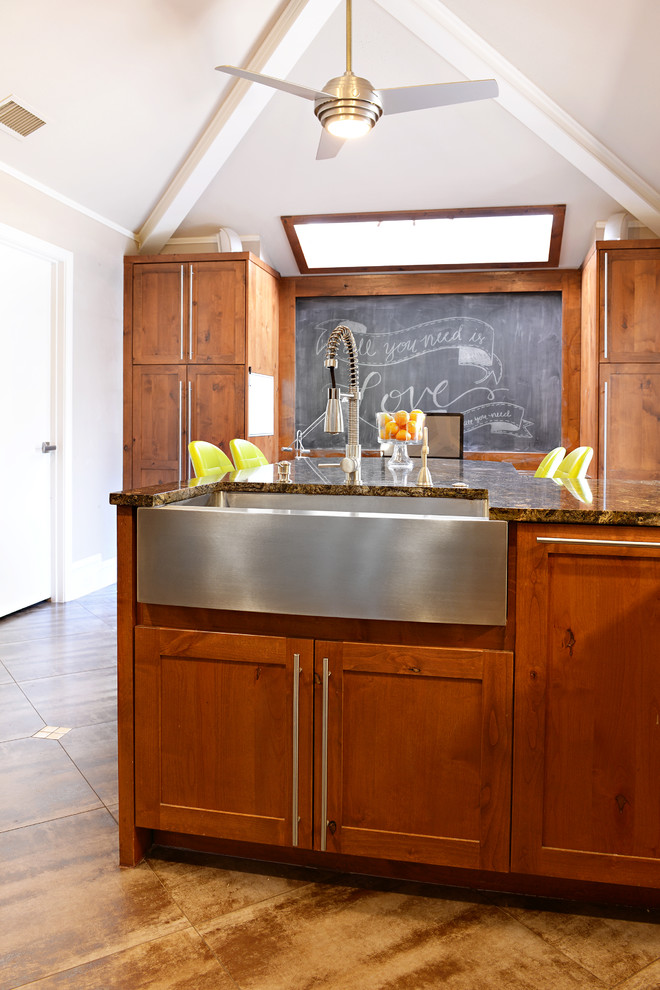 Example of a large transitional u-shaped travertine floor eat-in kitchen design in Dallas with a farmhouse sink, medium tone wood cabinets, granite countertops, multicolored backsplash, matchstick tile backsplash, stainless steel appliances and a peninsula